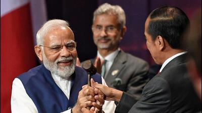 Bali, Nov 16 (ANI): President of Indonesia Joko Widodo symbolically handed over the G20 Presidency to Prime Minister Narendra Modi at the G20 summit, in Bali on Wednesday. (ANI Photo) (ANI/ PIB)