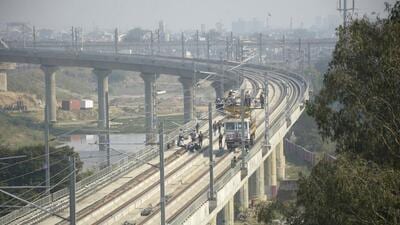 The rapid rail bridge and the rapid rail line over the Hindon river in Ghaziabad have been installed and the workers of the rapid rail are working on the electric poles, in Ghaziabad on November 19. (Sakib Ali/HT Photo) The rapid rail bridge and the rapid rail line over the Hindon river in Ghaziabad have been installed and the workers of the rapid rail are working on the electric poles, in Ghaziabad on November 19. (Sakib Ali/HT Photo)