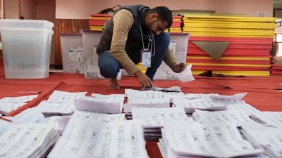 Nepal Elections: An election commission staff separates ballot papers to count. (AP) Nepal Elections: An election commission staff separates ballot papers to count. (AP)