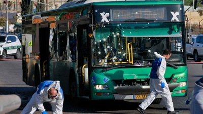 Israeli forensic experts gather at the scene of an explosion at a bus stop in Jerusalem on November 23, 2022. (AFP) Israeli forensic experts gather at the scene of an explosion at a bus stop in Jerusalem on November 23, 2022. (AFP)