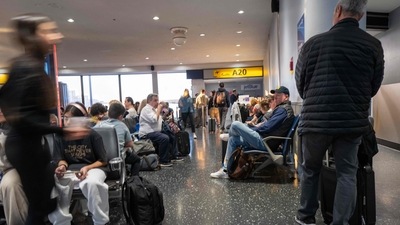 People walk through Newark Liberty International Airport on the day before one of the busiest travel days of the year. (Getty Images via AFP) People walk through Newark Liberty International Airport on the day before one of the busiest travel days of the year. (Getty Images via AFP)