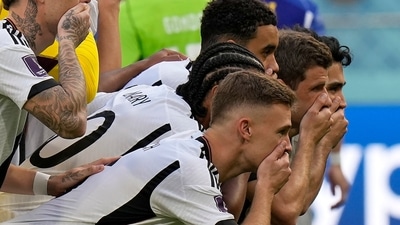 Germany players put their hands on their mouths as they pose for a group photo (AP)