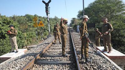 Police personnel inspecting the tracks after three siblings jumped from a railway bridge, in Jammu on Wednesday. (ANI Photo)