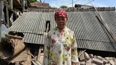 Resident Mimin poses by the rubble of her collapsed house in Cugenang, Cianjur on November 23, 2022, following a 5.6-magnitude earthquake that hit the area on November 21. (AFP) Resident Mimin poses by the rubble of her collapsed house in Cugenang, Cianjur on November 23, 2022, following a 5.6-magnitude earthquake that hit the area on November 21. (AFP)