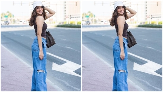 Sharvari wore a dark brown-coloured sleeveless crop top featuring thin straps, a quirky slogan on the front, a fitted silhouette, and a cropped hem length. She teamed the top with distressed denim jeans.(Instagram)