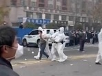 Security personnel in protective clothing were seen taking away a person during protest at the factory compound operated by Foxconn Technology Group who runs the world's biggest Apple iPhone factory in Zhengzhou in central China's Henan province.(AP) Security personnel in protective clothing were seen taking away a person during protest at the factory compound operated by Foxconn Technology Group who runs the world's biggest Apple iPhone factory in Zhengzhou in central China's Henan province.(AP)