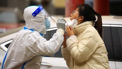 A health worker takes a swab sample from a resident to be tested for Covid-19 in Jiayuguan, in China’s northwestern Gansu province on Thursday. (AFP) A health worker takes a swab sample from a resident to be tested for Covid-19 in Jiayuguan, in China’s northwestern Gansu province on Thursday. (AFP)