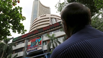 A man looks at a screen across a road displaying the Sensex on the facade of the Bombay Stock Exchange (BSE) building in Mumbai. (REUTERS)