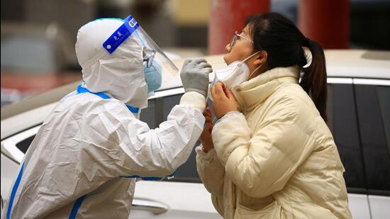 A health worker takes a swab sample from a resident to be tested for Covid-19 in Jiayuguan, in China’s northwestern Gansu province on Thursday. (AFP)