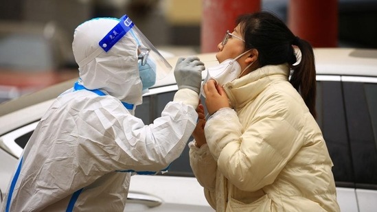 A health worker takes a swab sample from a resident to be tested for Covid-19 in Jiayuguan, in China’s northwestern Gansu province on Thursday. (AFP) A health worker takes a swab sample from a resident to be tested for Covid-19 in Jiayuguan, in China’s northwestern Gansu province on Thursday. (AFP)