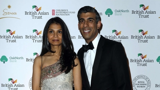 Britain's Chancellor of the Exchequer Rishi Sunak (R) poses with his wife Akshata Murty.(AFP)