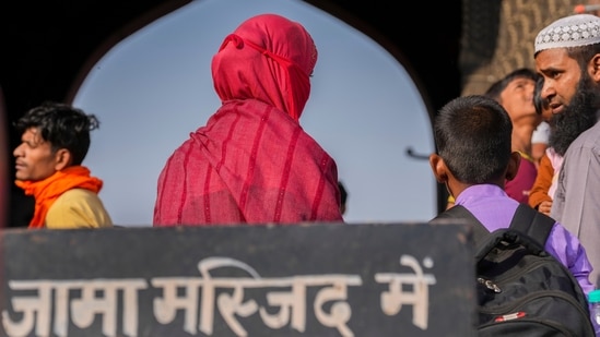 A woman leaves the Jama Masjid, in New Delhi, Thursday, Nov. 24, 2022. (PTI Photo/Ravi Choudhary)