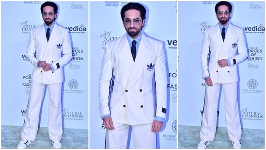 Ayushmann Khurrana attended the Forces Of Fashion event in a white suit from the Gucci X Adidas collection. It features a notch lapel double-breasted blazer, flared pants, a light blue button-down shirt and a navy blue tie rounded off with sunglasses and sneakers.(HT Photo/Varinder Chawla)