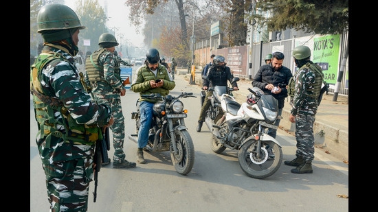 Security personnel frisk bike riders during high-alert following the recent killings of non-locals and threat to journalists and reporters based in Kashmir, in Srinagar. (PTI)