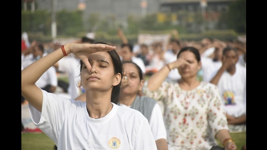 People doing breathing exercises as part of a yoga performance on International Day of Yoga on Tuesday, June 21, 2022. (Sakib Ali /Hindustan Times)