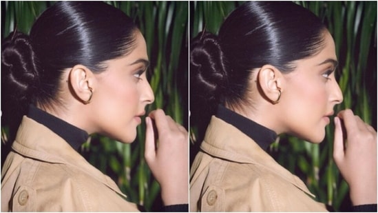 Sonam decked up in a black top with turtle neck details, and a pair of black formal trousers. She added more winter vibes to her look with an ochre trench coat placed on her shoulders, and an ochre long kilt with one thigh high slit.(Instagram/@sonamkapoor)