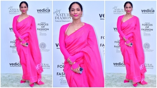 Masaba Gupta made a case for the colour of the season 'Neon/Rani Pink' in a gorgeous six yards and a matching blouse. She wore the bright look with matching rani pink pointed high heels, a statement ring, gold bracelet, sleek chain, hoop ear studs, bold makeup, neon pink lip shade, and a centre-parted bun.(HT Photo/Varinder Chawla)