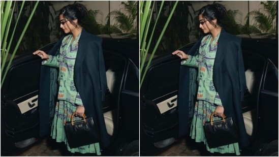 Sonam decked up in a pastel blue long dress featuring quirky prints in shades of black, orange and dark blue. She further layered her look with a long black trench coat and knee-length black leather boots.(Instagram/@sonamkapoor)