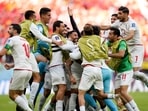 Iran's Rouzbeh Cheshmi, not seen, celebrates scoring the opening goal with teammates during the World Cup group B soccer match between Wales and Iran, at the Ahmad Bin Ali Stadium in Al Rayyan , Qatar, Friday, Nov. 25, 2022.(AP) Iran's Rouzbeh Cheshmi, not seen, celebrates scoring the opening goal with teammates during the World Cup group B soccer match between Wales and Iran, at the Ahmad Bin Ali Stadium in Al Rayyan , Qatar, Friday, Nov. 25, 2022.(AP)