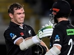 New Zealand's Tom Latham, left, celebrates his century with batting partner Kane Williamson while playing India in their one day international cricket match in Auckland, New Zealand, Friday, Nov. 25, 2022.