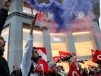 People hold flags from Spain's CGT labour union as they protest outside a Zara clothing store, an Inditex brand, for an increase in salaries amidst inflation hikes, in Madrid, Spain, November 24.