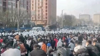 Covid In China: Protesters face off against security personnel at the factory compound operated by Foxconn in China. (AP) Covid In China: Protesters face off against security personnel at the factory compound operated by Foxconn in China. (AP)