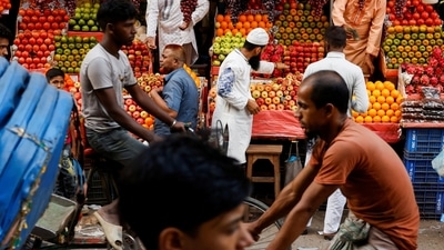 Bangladesh: Commuters pass by a fruit shop in Dhaka, Bangladesh. (Reuters)