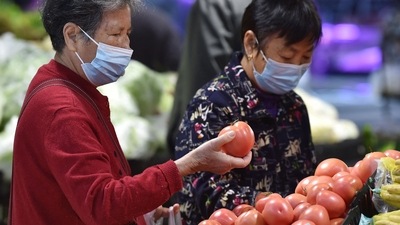 Covid In China: A customer shops for vegetables at a supermarket in Nanjing. (AFP)
