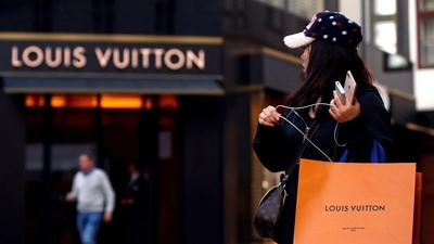A woman with a Louis Vuitton-branded shopping bag. (Reuters)