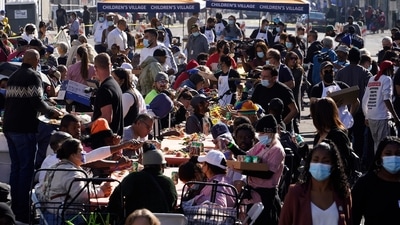 People partake in a free meal provided by the Union Rescue Mission as the district annual feast hosts thousands of homeless in downtown Los Angeles. (AP) People partake in a free meal provided by the Union Rescue Mission as the district annual feast hosts thousands of homeless in downtown Los Angeles. (AP)