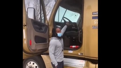 The image, taken from the viral video, shows the man parking a truck while controlling the steering wheel from outside. (Screengrab)