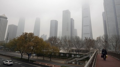 China: A man wearing a face mask walks on a pedestrian bridge. (AP)