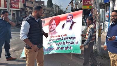 Ludhiana MC team removing hoardings installed by Congress councillor Baljinder Bunty in his ward. (Gurpreet Singh/HT)