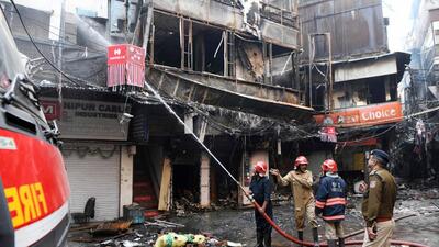 A team of firefighters spraying water at shops of Bhagirath Palace market gutted by the fire, in Chandni Chowk in Old Delhi on Friday. (ANI) A team of firefighters spraying water at shops of Bhagirath Palace market gutted by the fire, in Chandni Chowk in Old Delhi on Friday. (ANI)