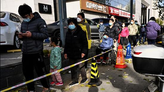 People queue for a swab to be tested for to Covid-19 coronavirus at a swab collection site in Beijing on Friday. (AFP)