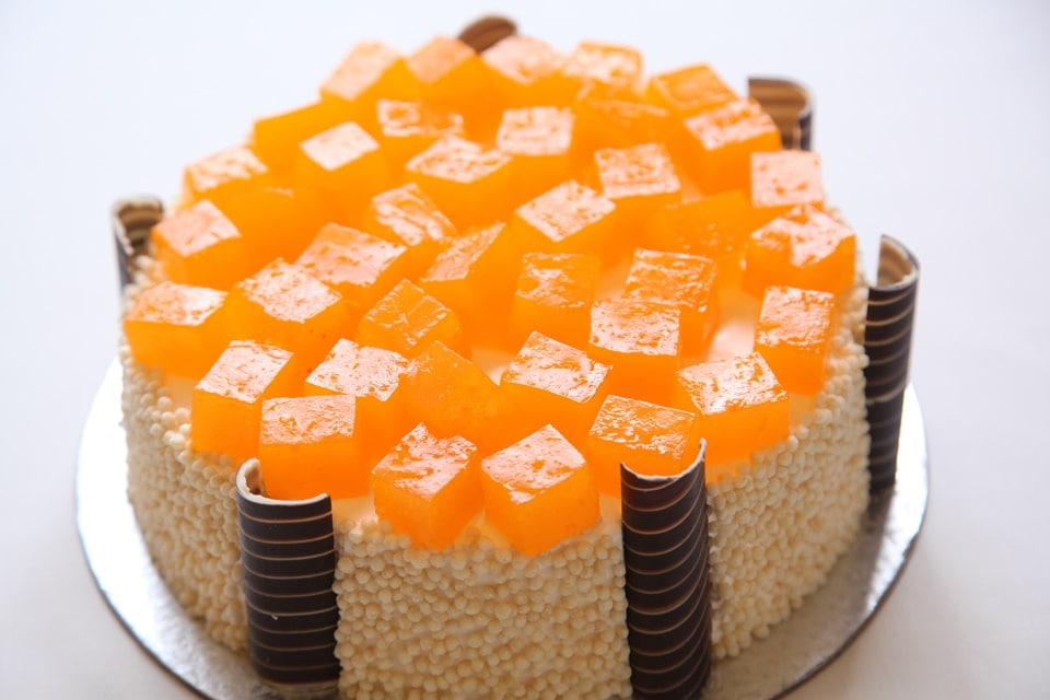 Cheesecake with orange and mango liqueur with sugar ball