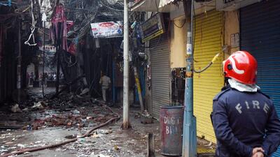A firefighter at at Bhagirath Palace market in Chandni Chowk in Delhi on Friday. (ANI)