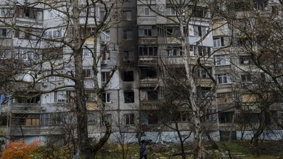 Russia-Ukraine War: A woman walks past a recently damaged building due to a Russian strike in Kherson. (AP)