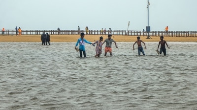 Chennai: Youngsters play at the flooded Marina Beach following incessant rains, in Chennai. (PTI file)