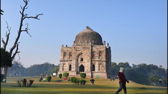 People walk on a smoggy morning at Lodhi Garden in New Delhi on Saturday. (Arvind Yadav/HT Photo)