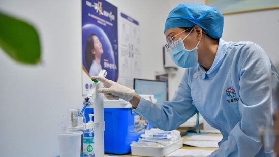 The country had recorded 32,943 new cases a day earlier – 3,103 symptomatic and 29,840 asymptomatic infections. (AFP)