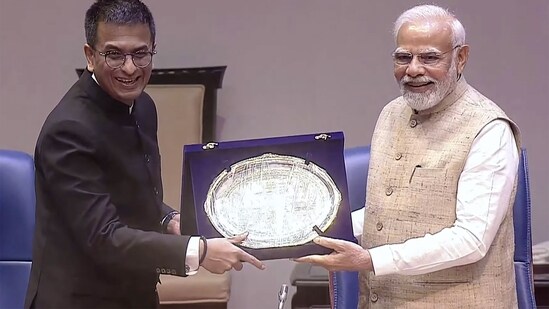 Prime Minister Narendra Modi being presented a memento by CJI DY Chandrachud during the Constitution Day celebrations in New Delhi on Saturday.(PTI)