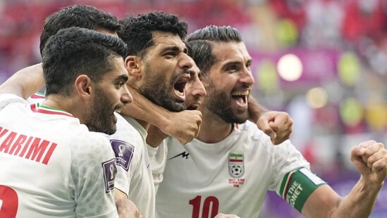 FIFA World Cup: Iran's team players celebrate at the end of the World Cup group B soccer match between Wales and Iran.(AP)