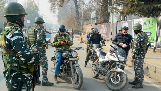 Security personnel frisk bike riders during high-alert following the recent killings of non-locals and threat to journalists and reporters based in Kashmir, in Srinagar. (PTI)