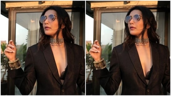 Styled by fashion stylist Ananya Arora, Karishma wore her tresses open in wavy curls with a middle part and decked up in nude eyeshadow, black eyeliner, mascara-laden eyelashes, contoured cheeks and a shade of maroon lipstick.(Instagram/@karishmaktanna)