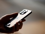 A man holds an iPhone 14