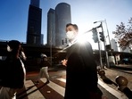 Covid In China: People walk across a street during morning rush hour, following the outbreak of the coronavirus disease.