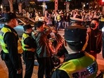 Police officers confront a man as they block Wulumuqi street, named for Urumqi in Mandarin, in Shanghai on Sunday in the area where protests against China's zero-Covid policy took place the night before following a deadly fire in Urumqi, the capital of the Xinjiang region. (AFP) Police officers confront a man as they block Wulumuqi street, named for Urumqi in Mandarin, in Shanghai on Sunday in the area where protests against China's zero-Covid policy took place the night before following a deadly fire in Urumqi, the capital of the Xinjiang region. (AFP)