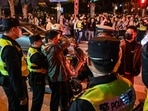 Police officers confront a man as they block Wulumuqi street, named for Urumqi in Mandarin, in Shanghai in the area where protests took place the night before following a deadly fire in Urumqi, the capital of the Xinjiang region. (AFP)