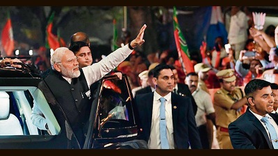 Prime Minister Narendra Modi during a roadshow in Surat on Sunday. (ANI) Prime Minister Narendra Modi during a roadshow in Surat on Sunday. (ANI)
